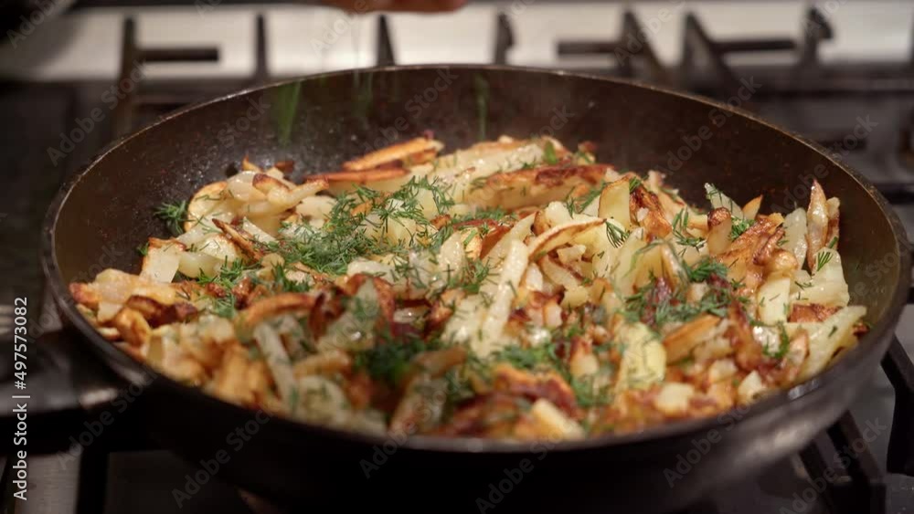 Frying sliced potatoes in a frying pan, on a gas stove. Dolly shot.
Frying sliced potatoes in a frying pan, on a gas stove. Dolly shot.