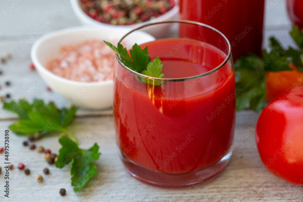 Juice from various vegetables and herbs on a wooden table. Healthy food rich in vitamins, microelements, antioxidants. Juice from various vegetables and herbs on a wooden table. Healthy food rich in vitamins, microelements, antioxidants.