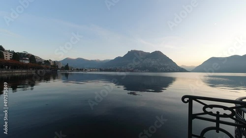 Sunrise on Lake Lugano with a view towards city, Switzerland. High quality 4k footage