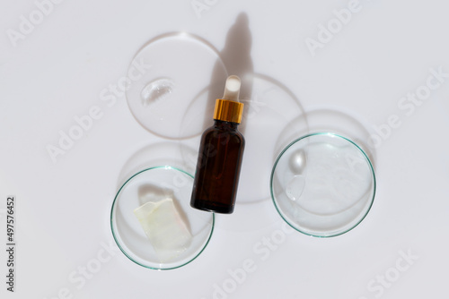 Glass petri dish with transparent pure serum for skin care