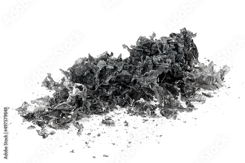 Pile of charred paper isolated on a white background. Burned paper scraps.