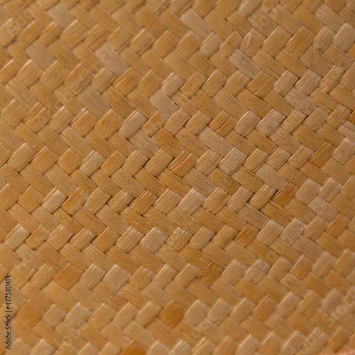 Fragment of dense and hard fabric made of light and dark yellow synthetic thread photo