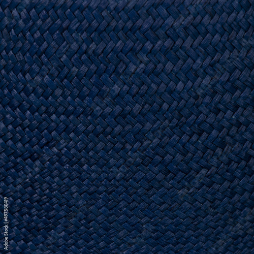 Fragment of dense, large and hard fabric made of very dark blue synthetic thread photo