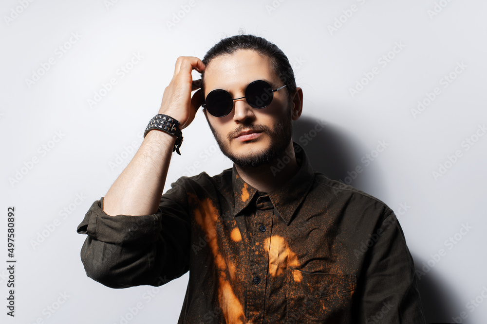 Studio portrait of young serious man on white background. Studio portrait of young serious man on white background.