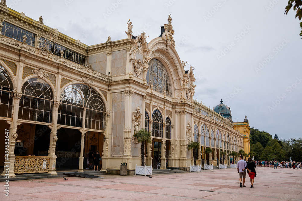 Obraz premium Marianske lazne, Czech Republic, 7 August 2021: Romantic architecture of Bohemia, spa city Marienbad, neo-Baroque Maxim Gorky's Colonnade with fountain, national cultural monument at sunny summer day
