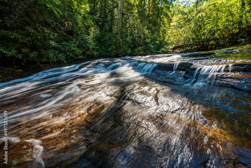 Water flows over rock slabs near Helton Creek Falls photo