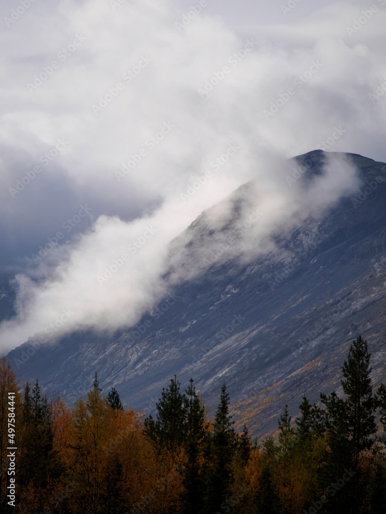 The clouds caught on the tops of the mountains. Low clouds in the mountains. Khibiny, Russia.