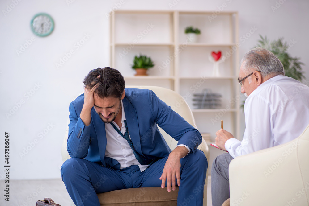 Young businessman employee visiting psychologist Young businessman employee visiting psychologist