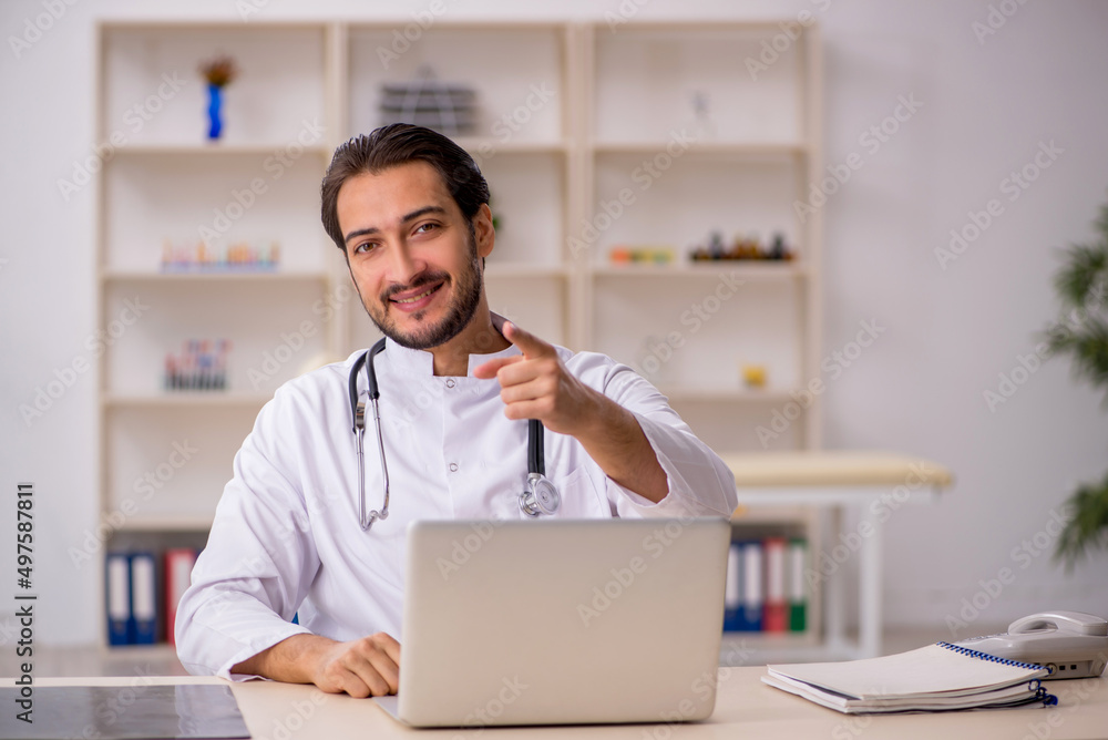 Young male doctor working in the clinic Young male doctor working in the clinic