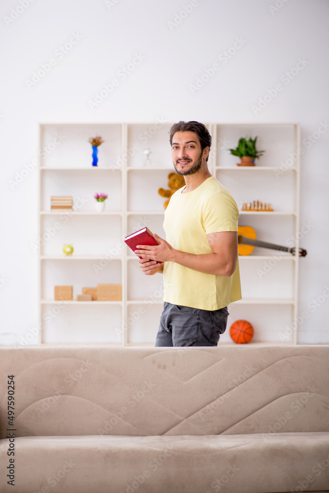 Young man reading book at home during pandemic Young man reading book at home during pandemic
