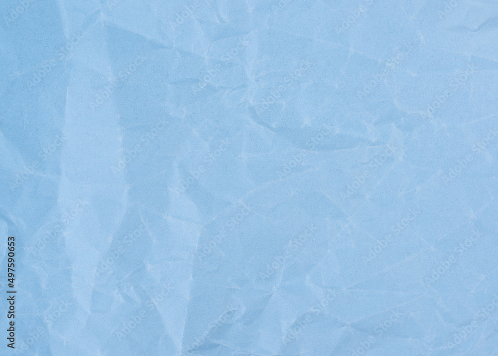 Fototapeta premium Wrinkled sheet of light blue paper. Textured backdrop