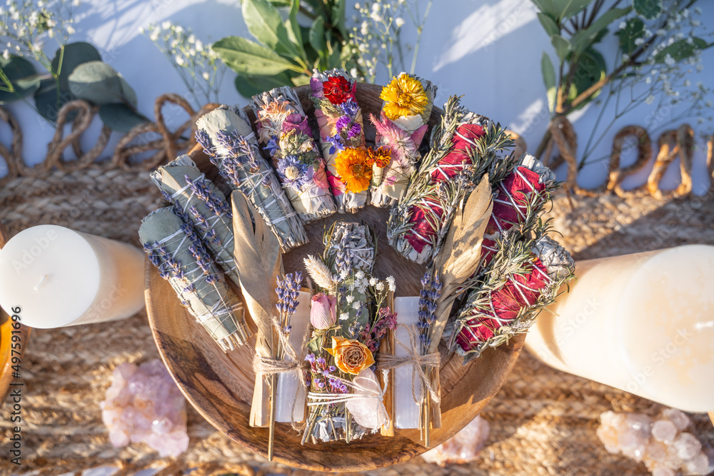 Top view of smudging sticks with dried flowers on a wooden tray Stock Photo