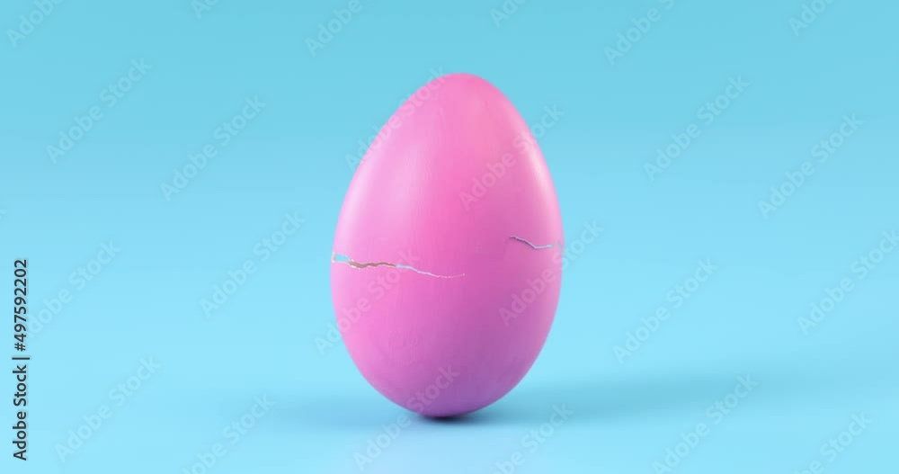 Pink Easter egg slowing cracking and breaking apart time lapse.