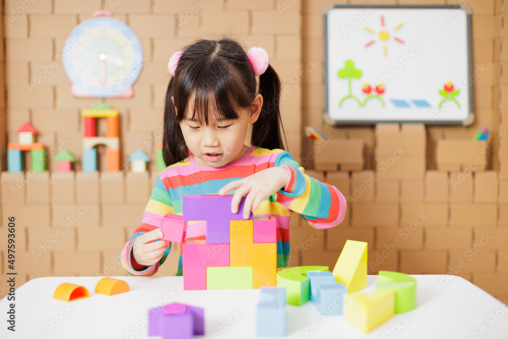 young girl playing creative toy blocks at home young girl playing creative toy blocks at home