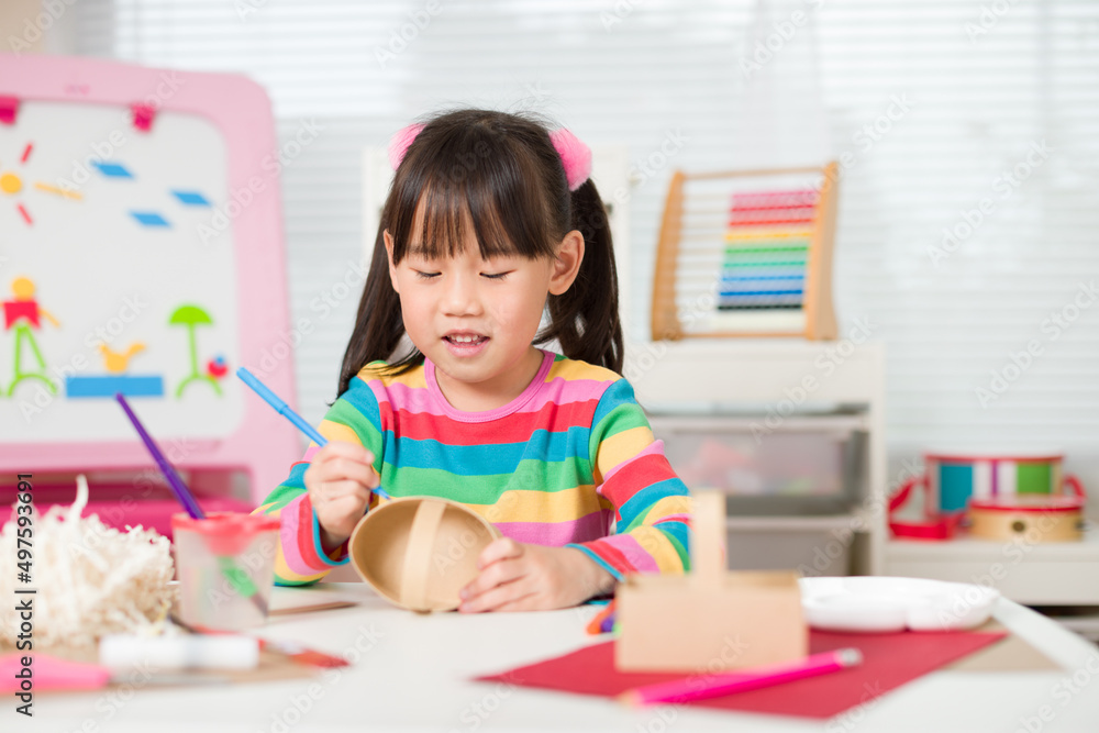 young girl making craft for home schooling young girl making craft for home schooling