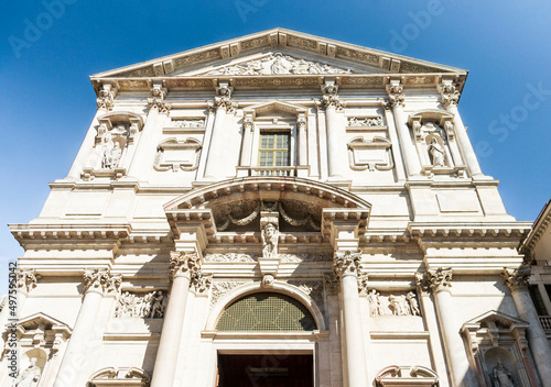 The façade of the church of Saint Fidelis (San Fedele) in the homonym square, with statues and niches, Milan city center, Lombardy region, Italy photo