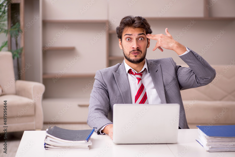Young male employee working from home during pandemic Young male employee working from home during pandemic
