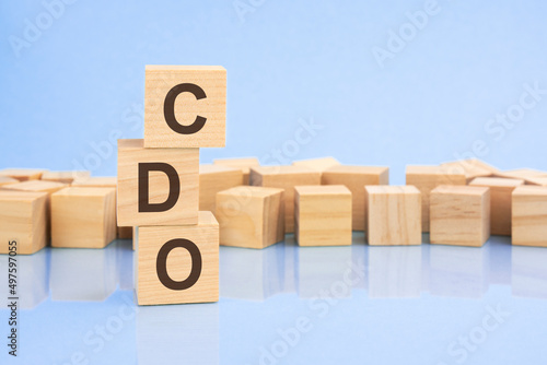 on a bright blue background, light wooden blocks and cubes with the text CDO photo