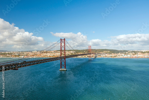 The 25 de Abril Bridge, 25th of April Bridge, a red suspension bridge over the Tagus river, Lisbon, Portugal