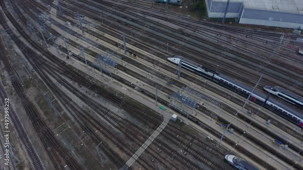 City famous train station rail ways aerial. Passenger Train Arriving On Station.  Train Station Aerial Drone. A drone flies over a train station. Aerial top view.