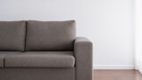 Grey couch against white copy space wall