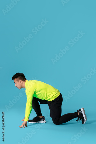 Sporty male runner on color...