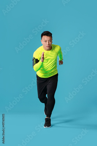 Sporty male runner on color...