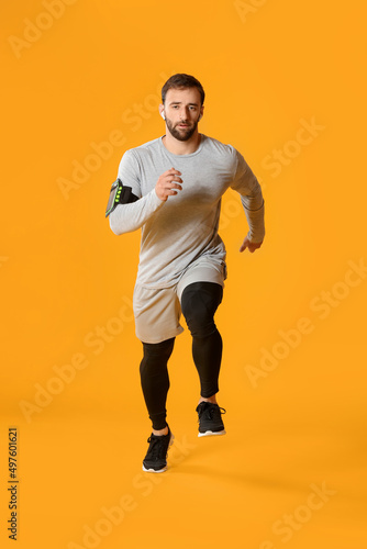 Sporty male runner on color...