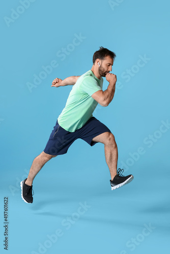 Sporty male runner on color...