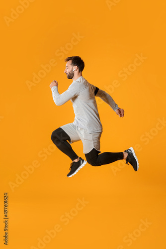 Sporty male runner on color...