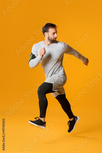 Sporty male runner on color...