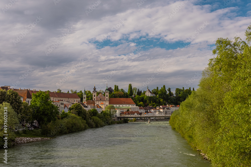 Beautiful panorama of the city of Steyr in upper Austria, rising above the river of Enns on the green river banks.
