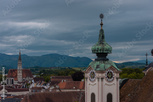 Collection of belltowers and roofs in the town of Steyr in upper austria, with peaks perking out from the rooftops.