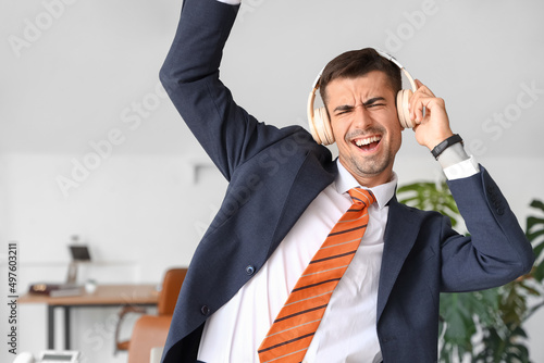 Dancing young businessman w...