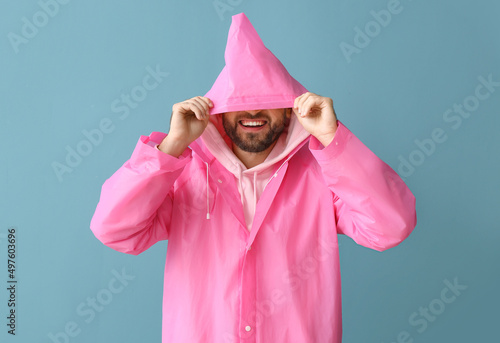 Young man in stylish rainco...