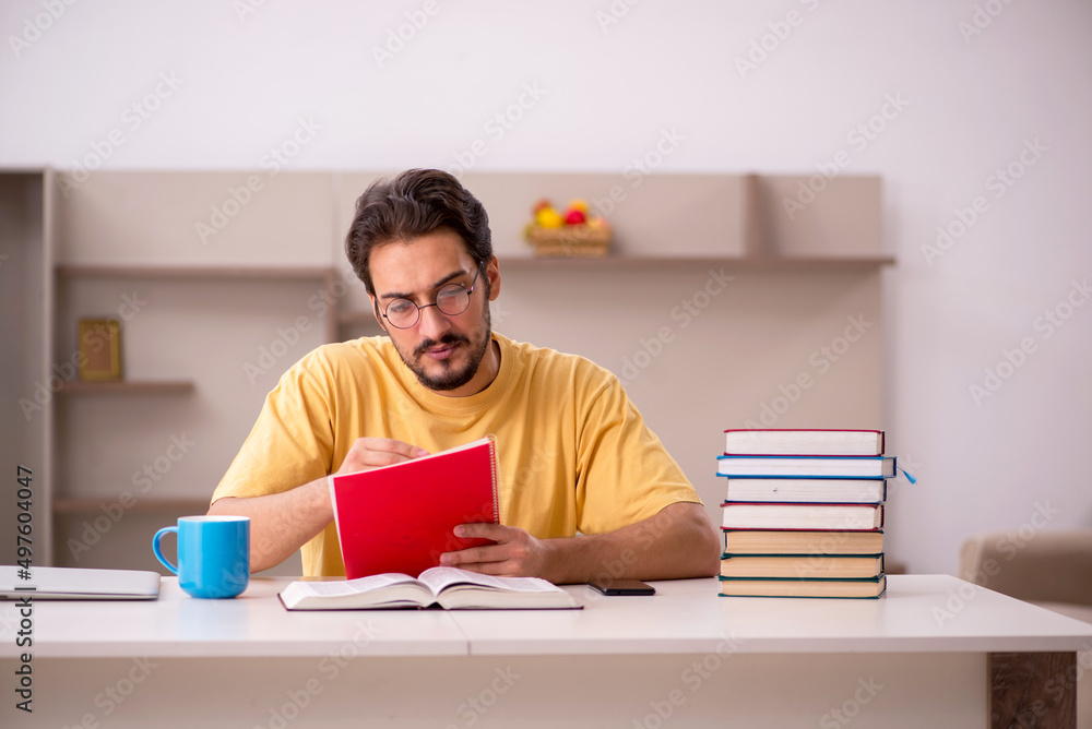 Young male student preparing for exams at home Young male student preparing for exams at home