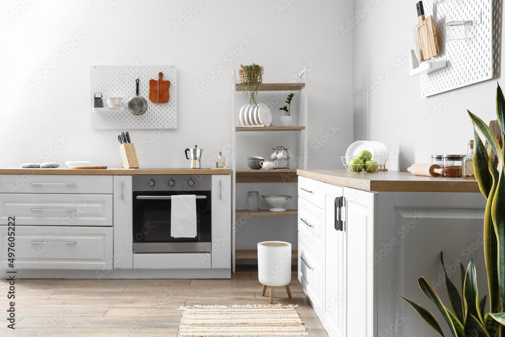 Modern shelving unit with tableware and counters in kitchen Modern shelving unit with tableware and counters in kitchen