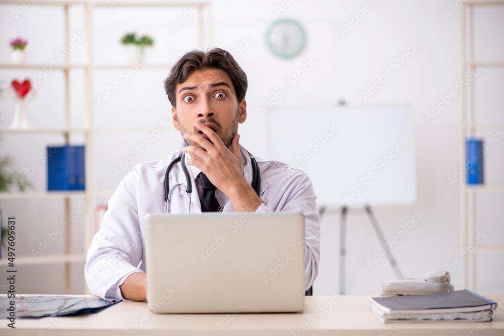Young male doctor in telemedicine concept Young male doctor in telemedicine concept