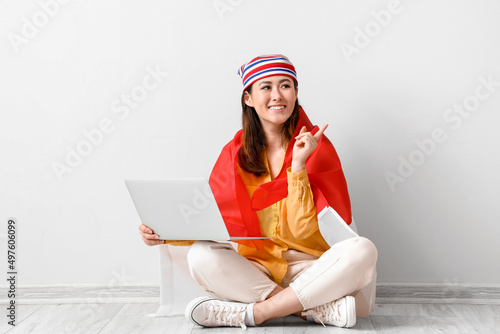 Young Asian woman with flag...