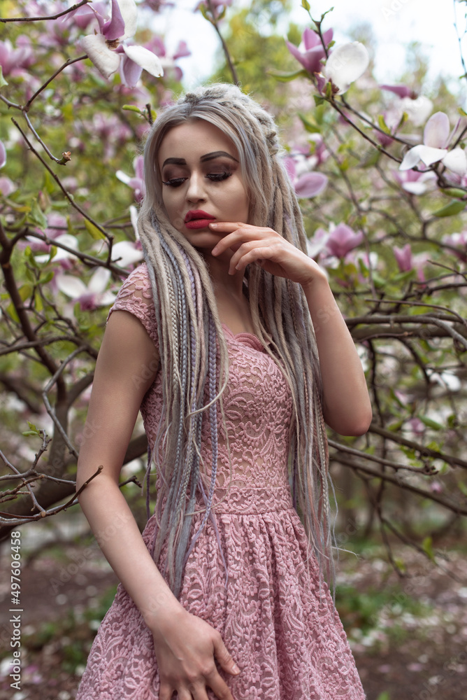 Girl in blooming magnolia garden Girl in blooming magnolia garden
