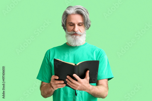 Senior man reading Holy Bib...