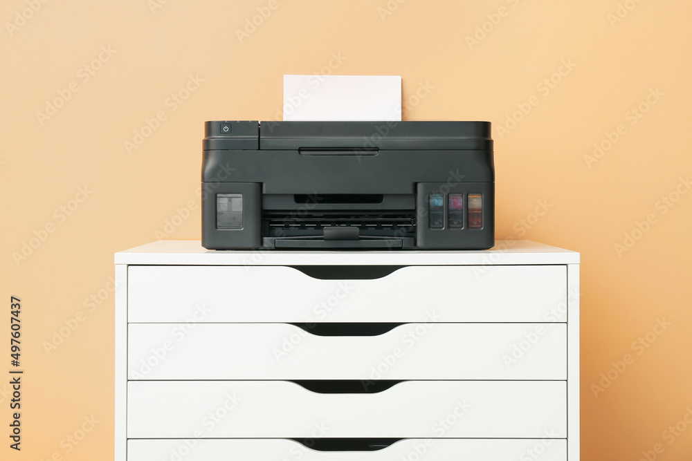 Modern printer on chest of drawers near color wall Modern printer on chest of drawers near color wall