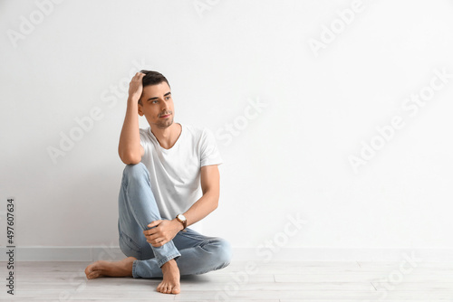 Young barefooted man sittin...