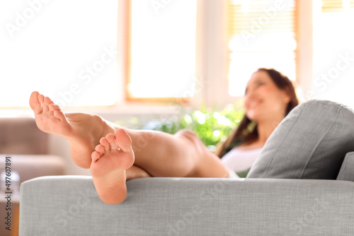 Bare feet of young woman ly...