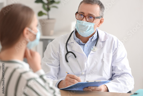 Ill woman with sore throat visiting doctor in clinic