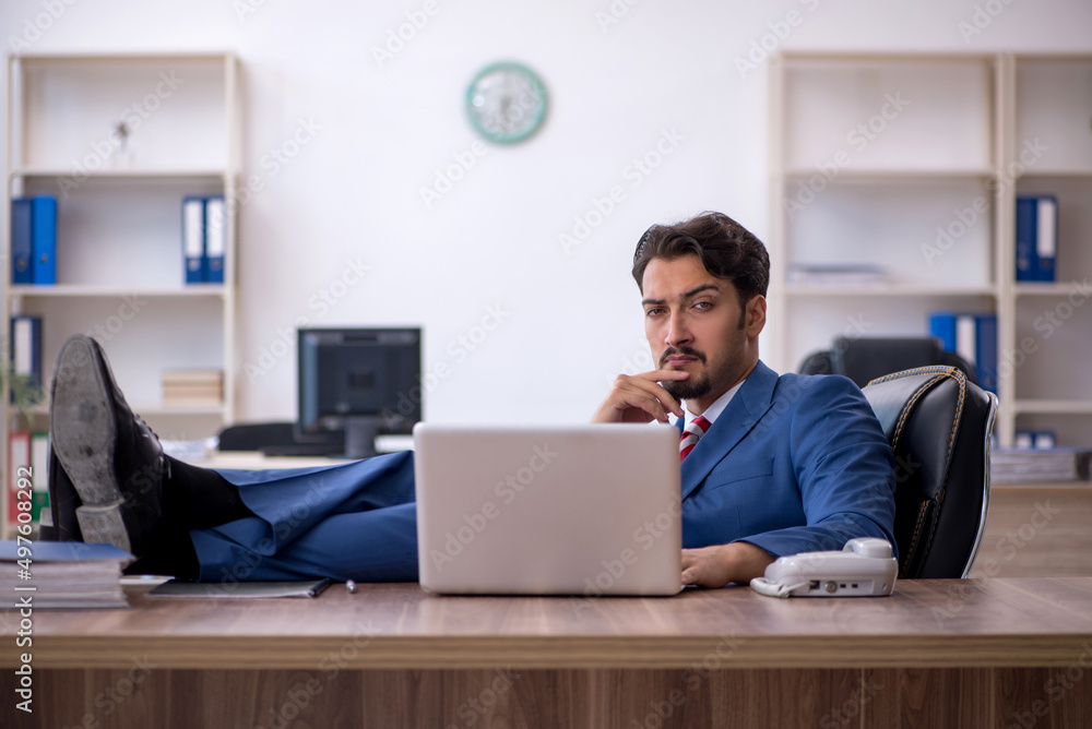 Young male employee working in the office Young male employee working in the office