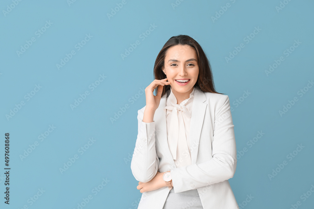 Portrait of young secretary on blue background Portrait of young secretary on blue background