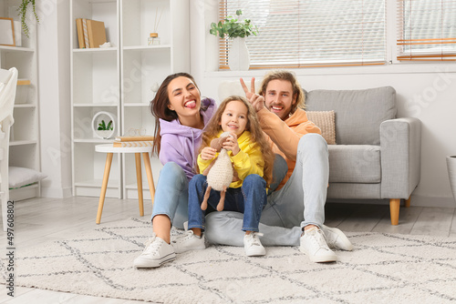 Young family sitting on sof...