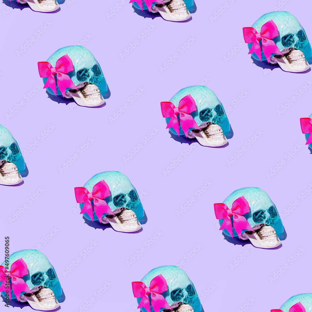 Creative pattern with skeleton head and bow, on pastel lilac backgrounds. A sweet idea about human life. Surreal fashion and trendy composition. Creative pattern with skeleton head and bow, on pastel lilac backgrounds. A sweet idea about human life. Surreal fashion and trendy composition.