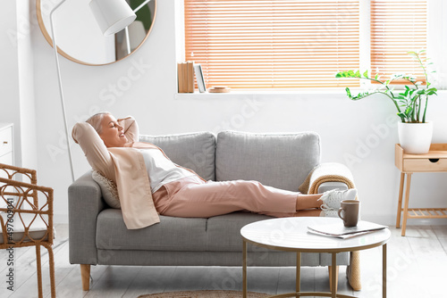 Mature woman relaxing on so...